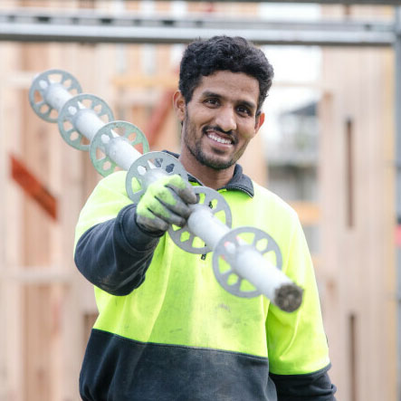 tradie-carrying-metal-piping